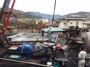 ミキサー車からポンプ車へ生コンが移され、流し込まれます